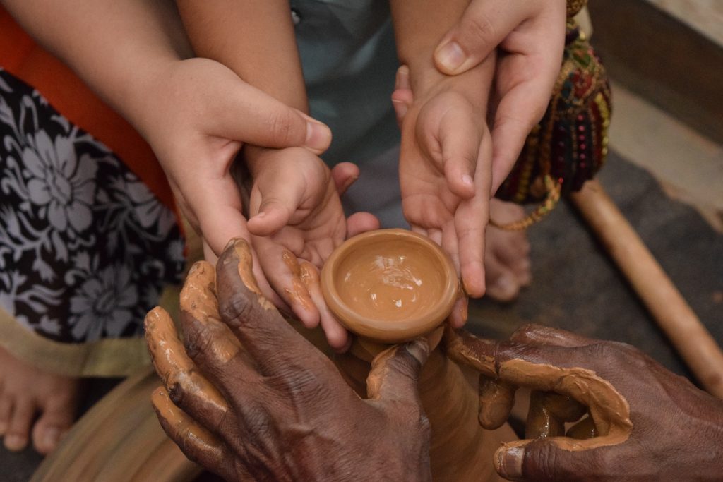 Woman and child hands shaping clay